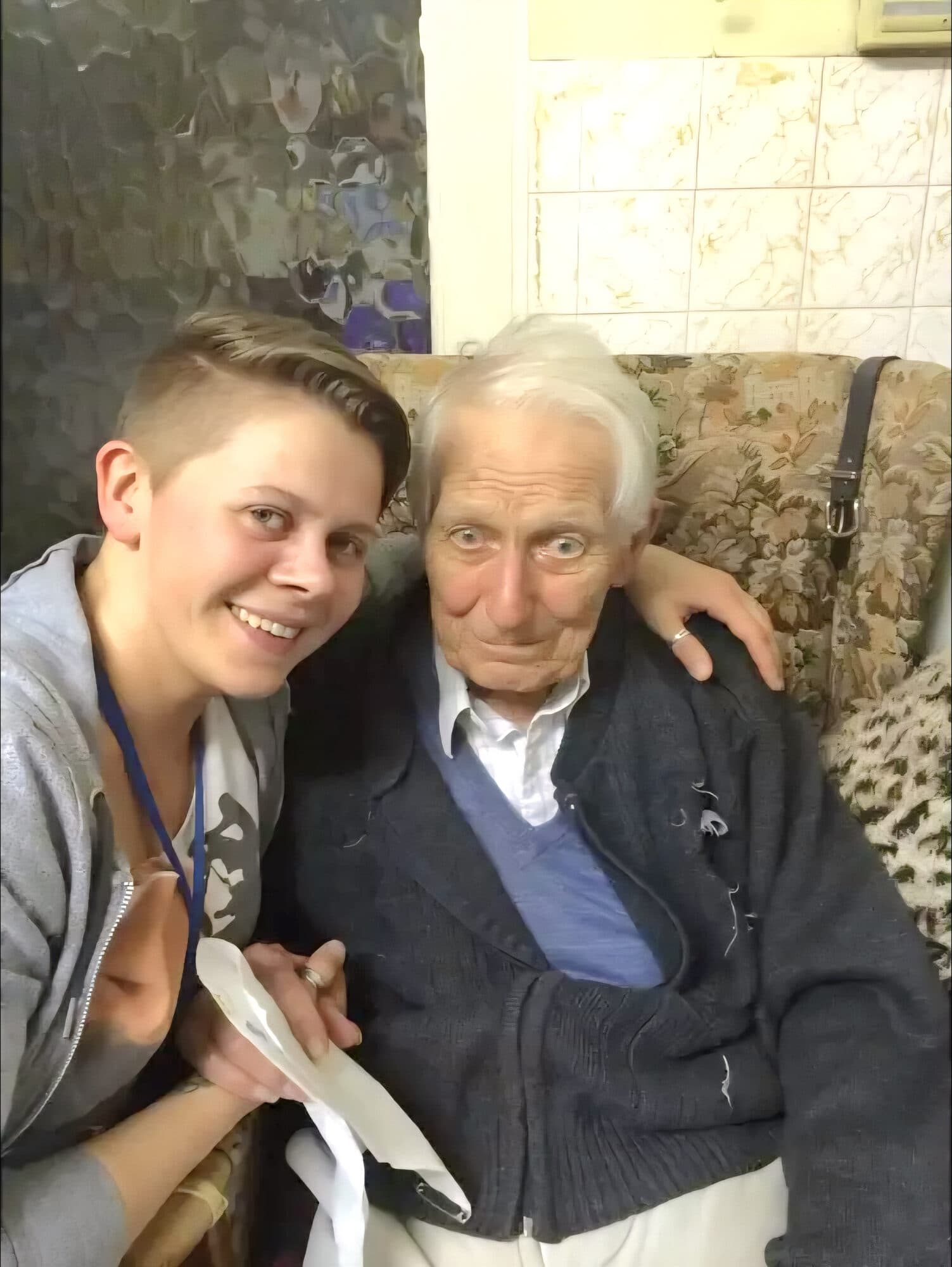 A Debbie Anne's carer with her arm around an elderly client at home