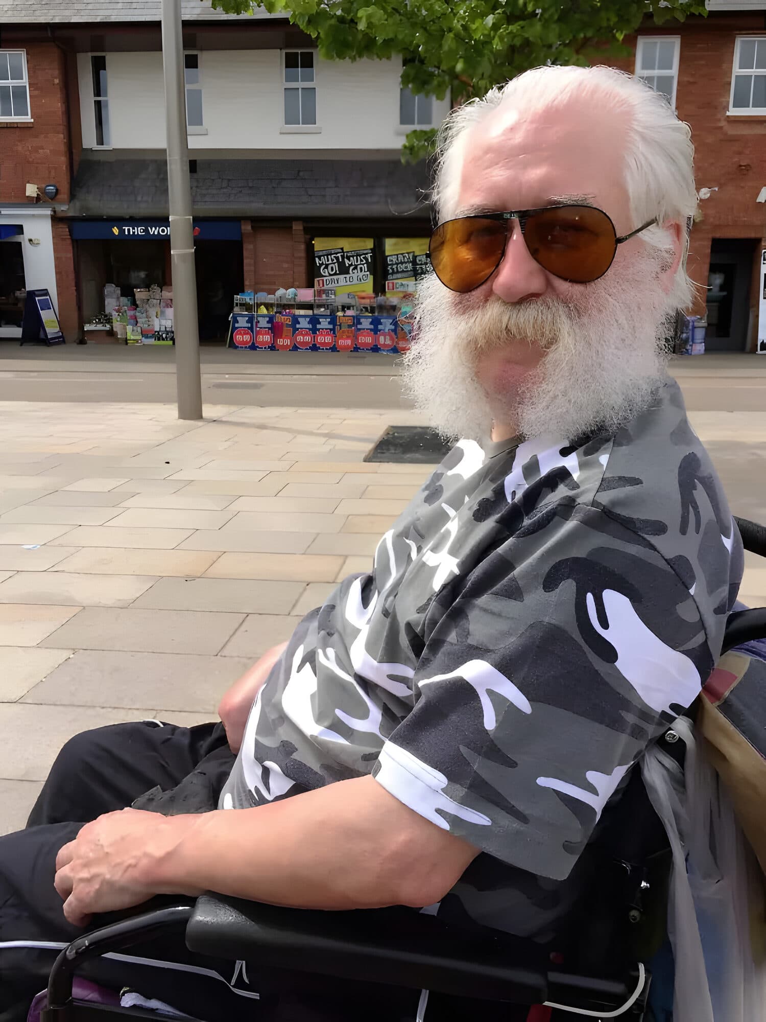 A client enjoying a day out in the town centre in his wheelchair